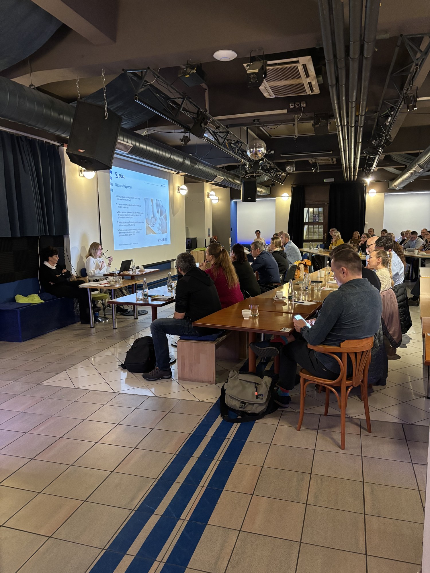 Participants at long tables during a training session