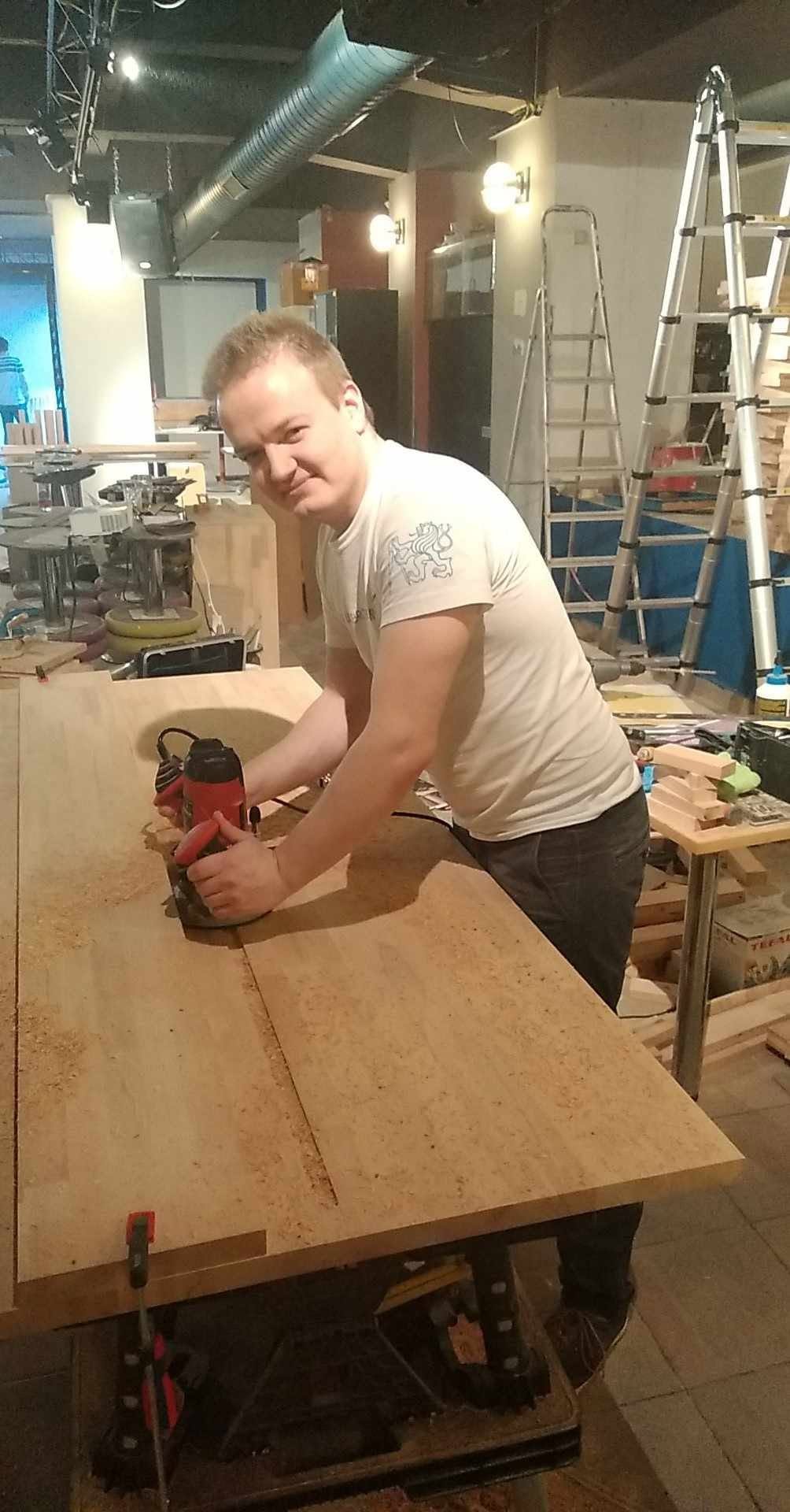 Sanding a wooden board for the furniture