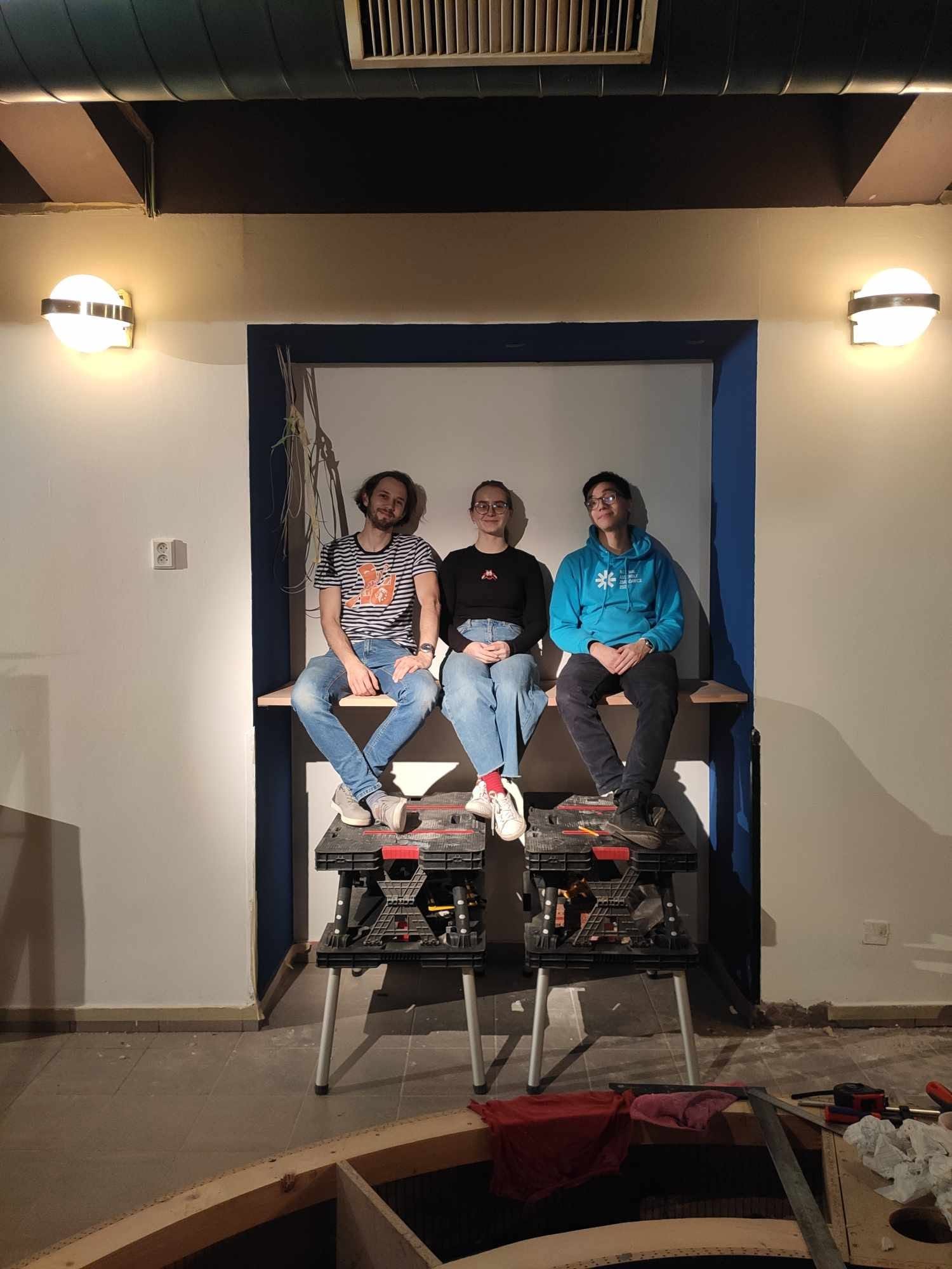 A group of club members in the doorway of the half-built bar