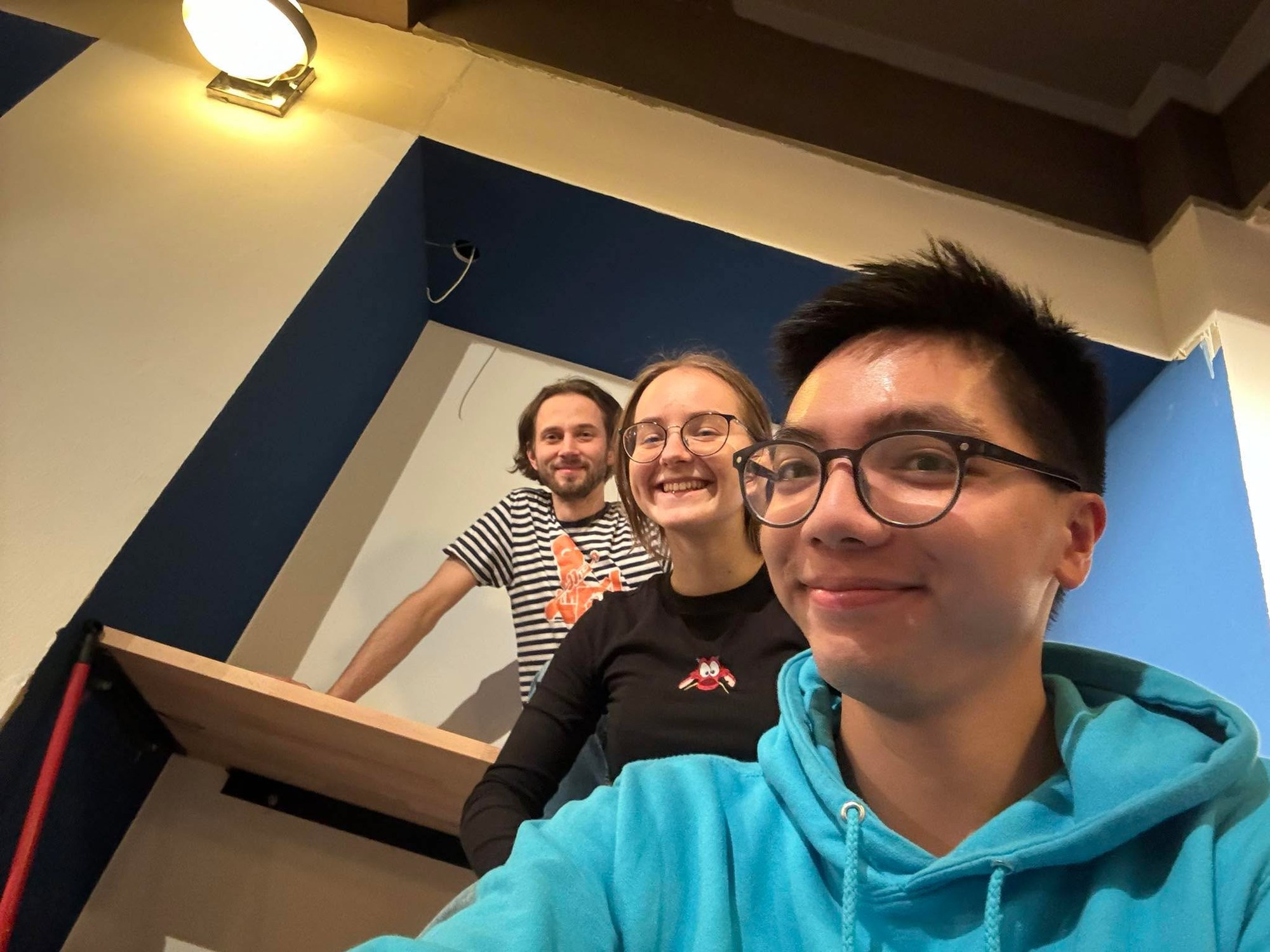 Four people taking a photo in the finished bar