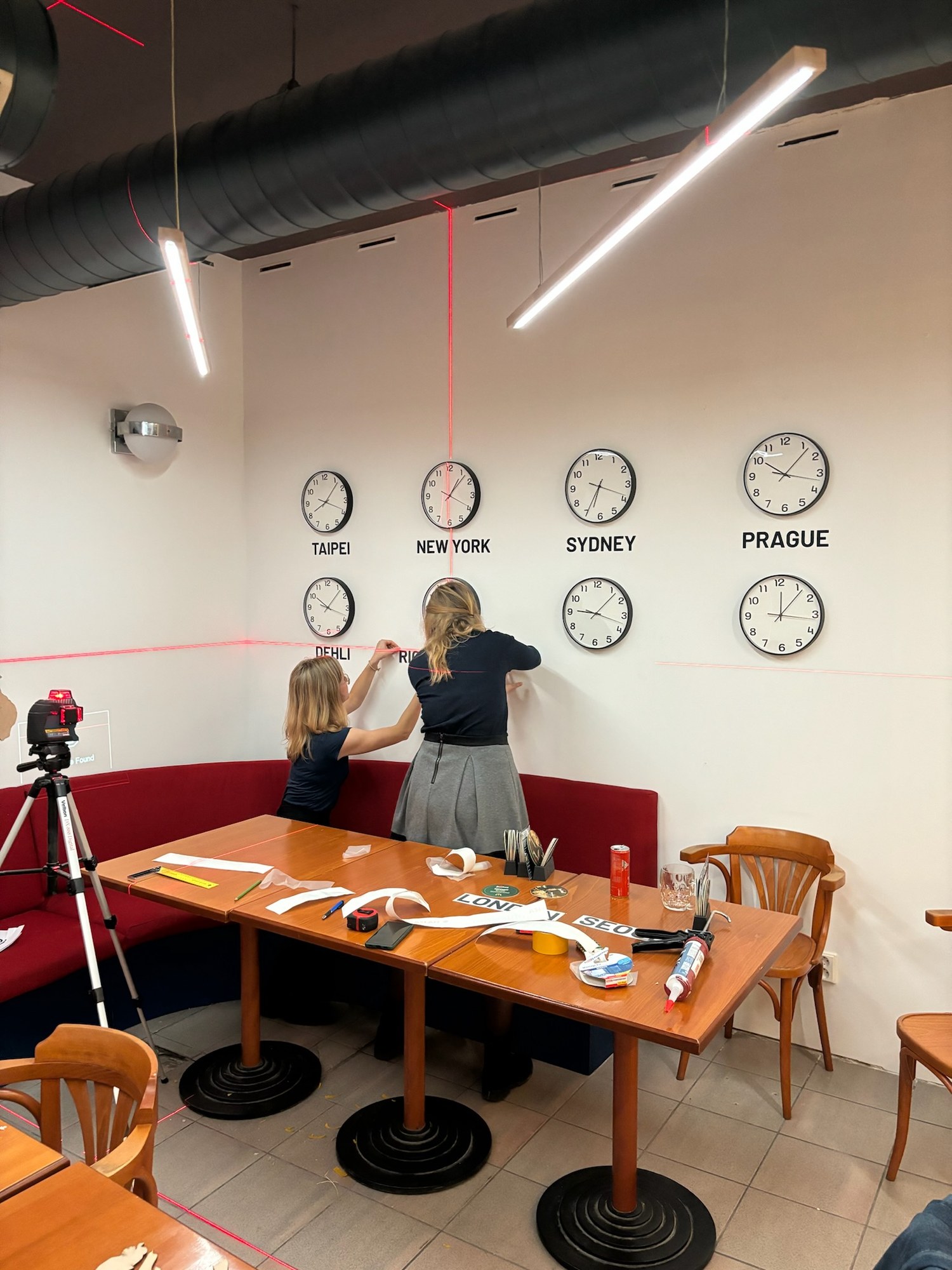 Hanging the world clocks on the wall using a laser level